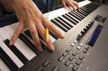 Songwriter working at a piano keyboard