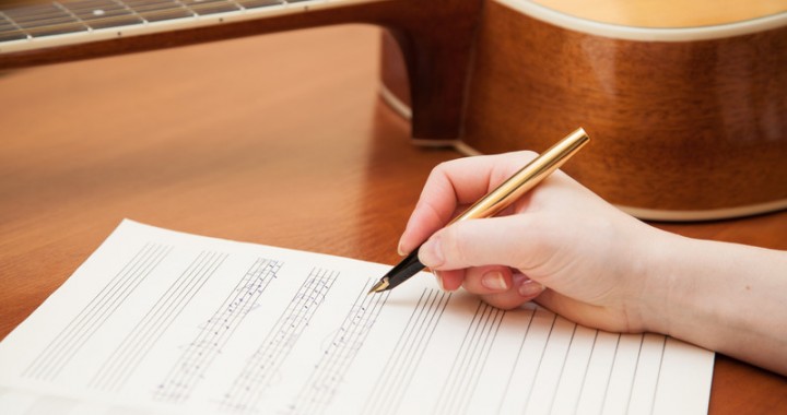 Songwriter with paper and guitar