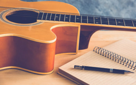 Guitar and paper for songwriting