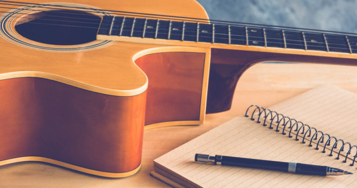 Guitar and paper for songwriting