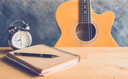 Guitar and Notepad - Songwriting schedule